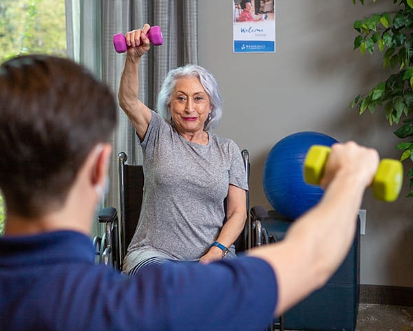 woman lifting dumbbells.