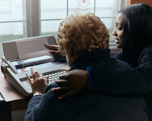 caregiver helping a resident type