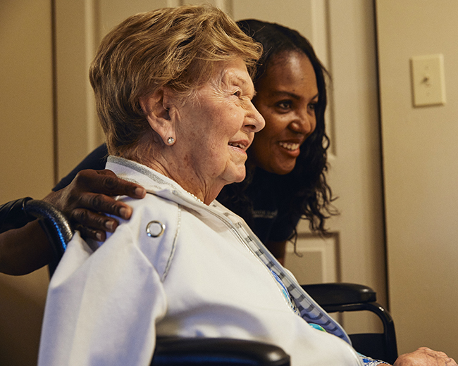 caregiver and woman smiling