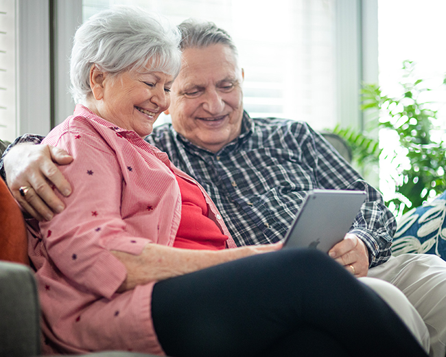 couple sitting with tablet