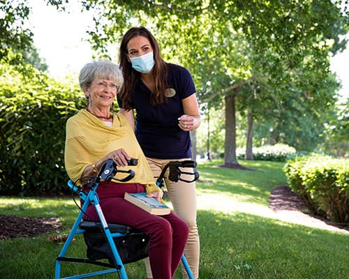 caregiver and woman standing outside