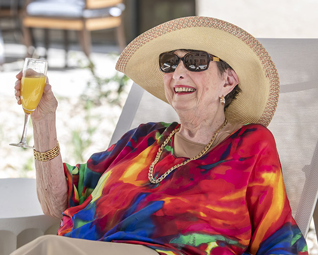 Woman drinking by pool