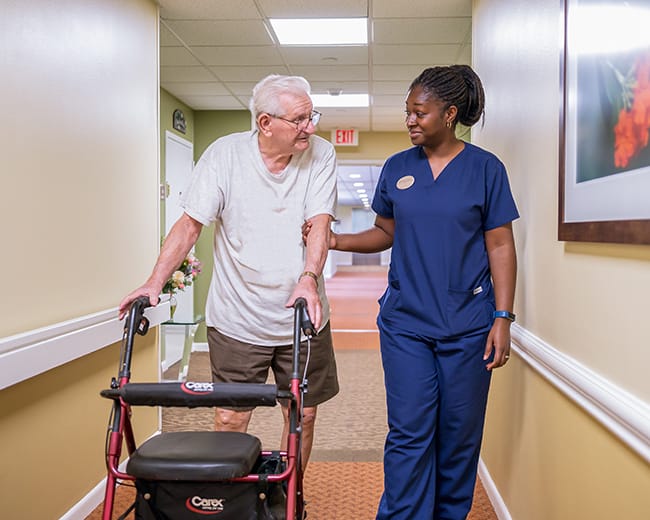 caregiver walking with a resident