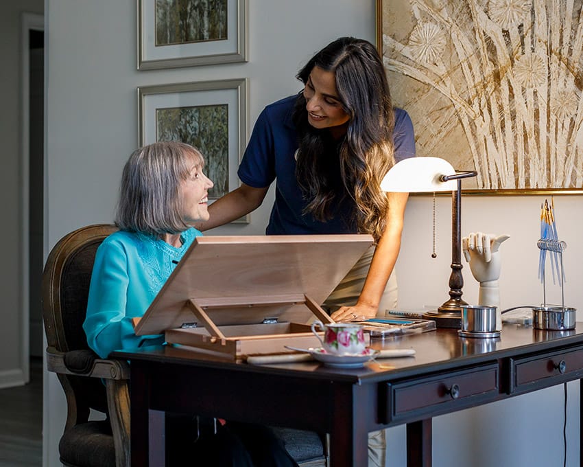 Woman painting with a caregiver