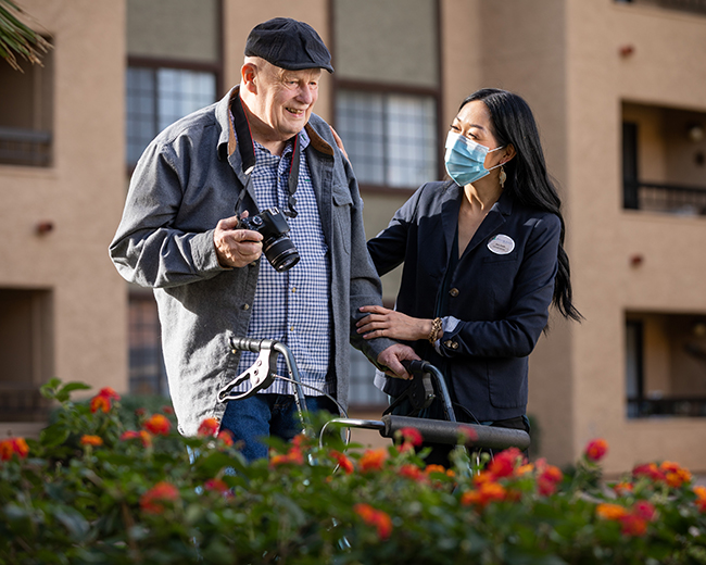 resident taking photos with caregiver