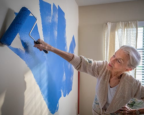 woman painting wall