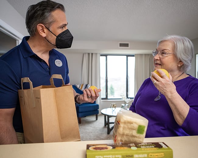 caregiver helping unpack groceries