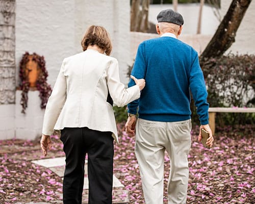 man and woman walking in courtyard