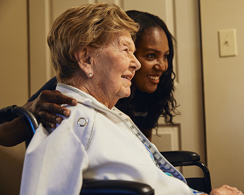 caregiver and resident smiling