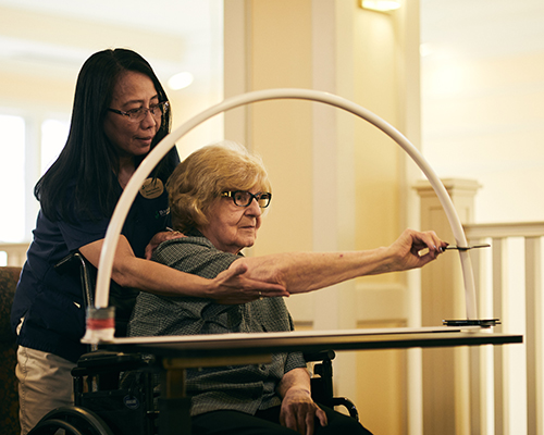 caregiver helping resident with a memory care activity