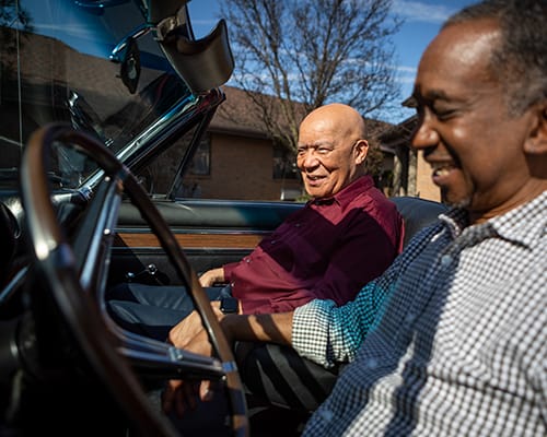 caregiver sitting in car with man