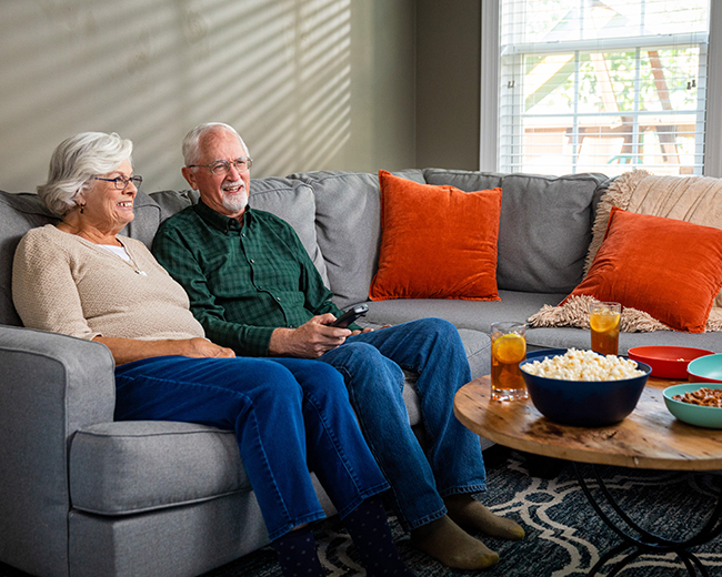couple watching TV with popcorn