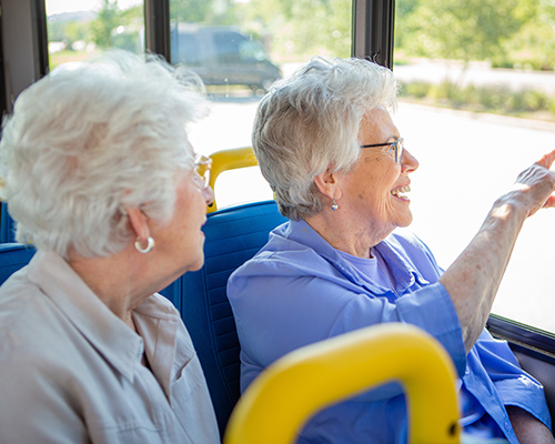women looking out bus window