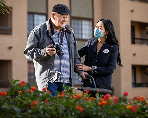 caregiver assisting resident with taking photos