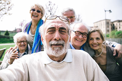 Grandfather taking selfie with family