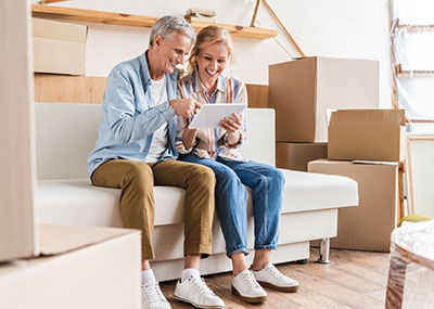 Senior couple reading documents from an iPad.