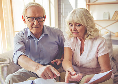 Senior couple reading bill