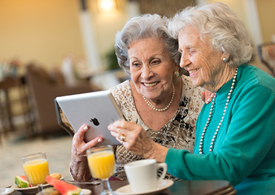 Senior friends looking at an iPad