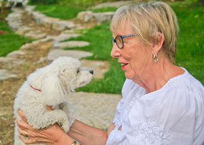 older woman holding dog