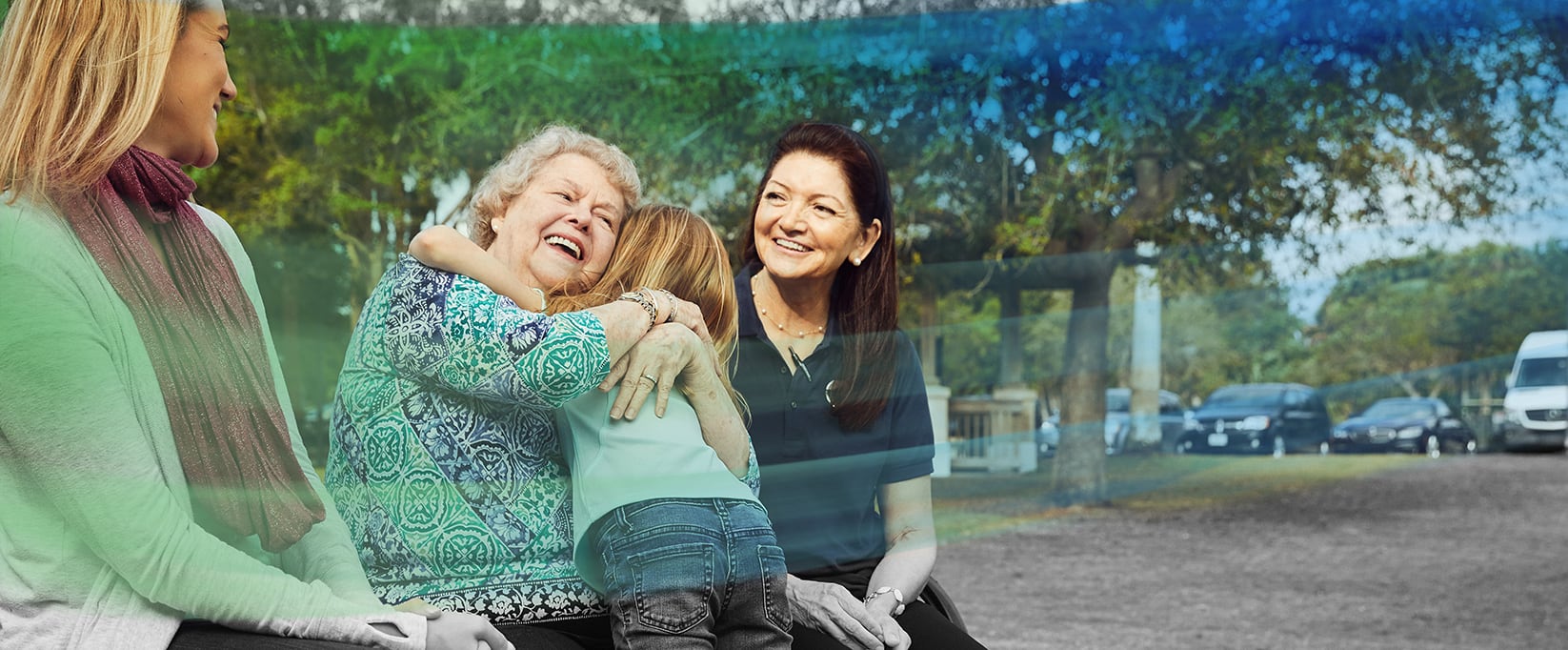 Caregiver and woman hugging grandchild