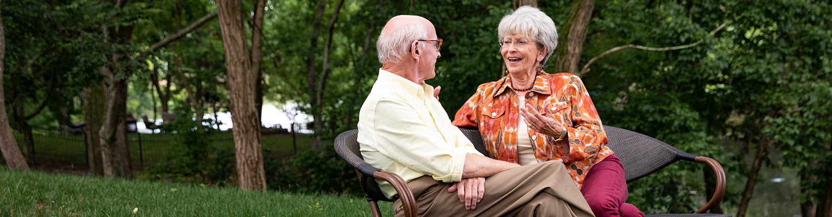 friends toasting next to swimming pool
