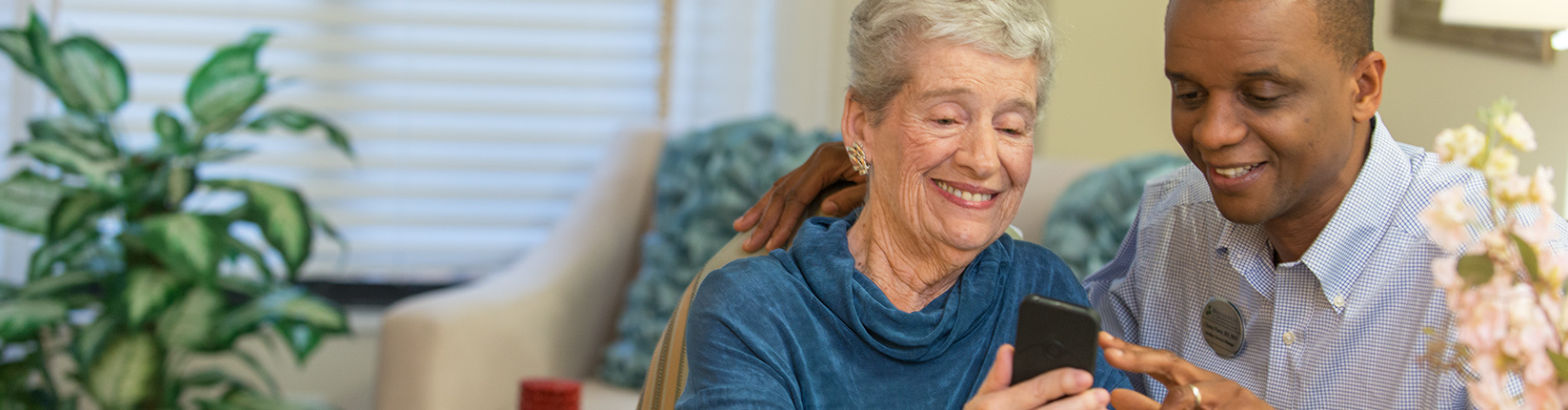 Associate Assisting Resident with Phone